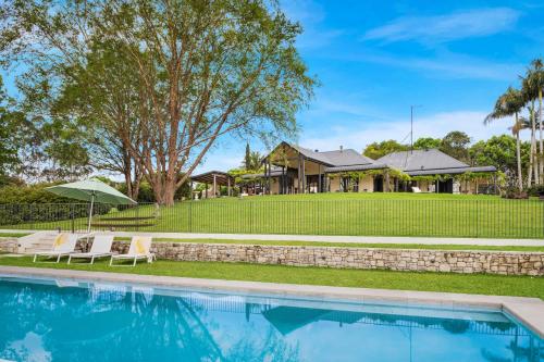 a house with a swimming pool in front of a yard at Fairway at Federal in Federal