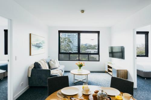 a living room with a couch and a table at Quest Mascot in Sydney