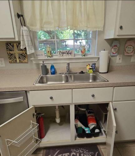 a kitchen counter with a sink and a window at Hazel's Happy Hideaway- Midtown Mobile! in Mobile