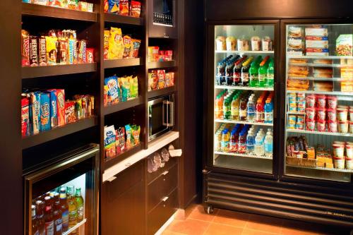 a store refrigerator filled with lots of food and drinks at Courtyard Cleveland Airport North in North Olmsted