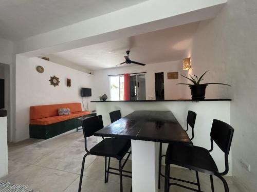a dining room and living room with a table and chairs at NEW MORINGA in Las Terrenas