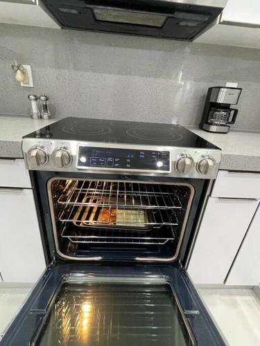 an oven with its door open in a kitchen at Flamingo Paradise in Hialeah