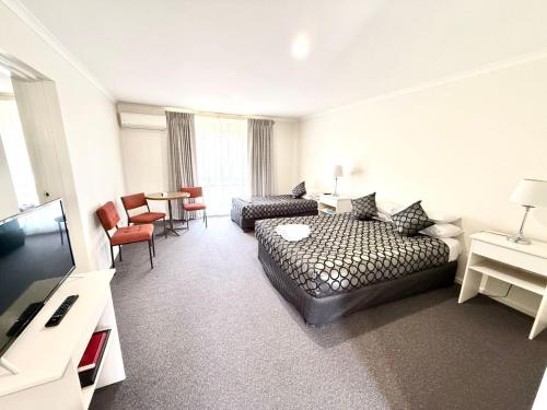 Ένα ή περισσότερα κρεβάτια σε δωμάτιο στο Redgum Motel