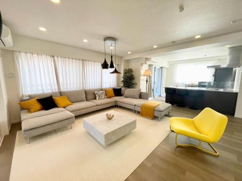 a living room with a couch and a table at Walk to Asakusa, Sky tree MAX16P in Tokyo