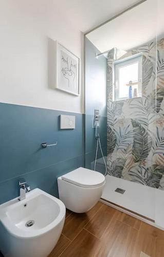 a bathroom with a toilet and a sink and a mirror at TheTinyHouse 70128 in Bari