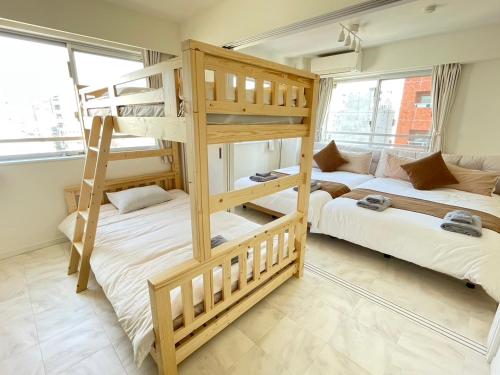 two bunk beds in a room with two beds at Walk to Asakusa, Sky tree MAX16P in Tokyo