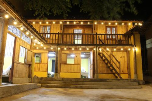 a house with a deck with lights on it at HaPu Homestay in Loung Co