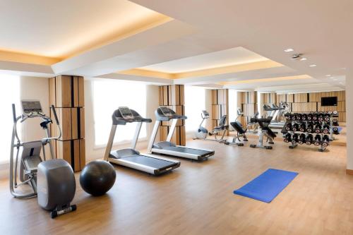 a gym with several treadmills and exercise bikes at Fairfield by Marriott Visakhapatnam in Visakhapatnam