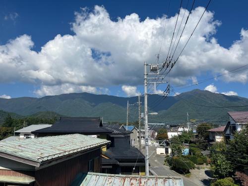 a view of a town with mountains in the background at ふる里 Mt Fuji Inn Furusato in Fujikawaguchiko