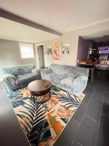 a living room with a couch and a table at Maxine Manor in Douglasville