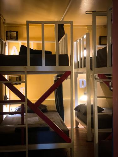 a room with three bunk beds in a room at Yellow Fellow Hostel in Chiang Mai