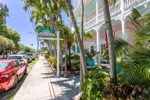 a street in front of a building with palm trees at The Palms Hotel in Key West