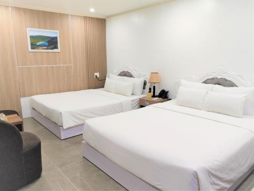 Ένα ή περισσότερα κρεβάτια σε δωμάτιο στο Pearl Beach Hotel Quy Nhon