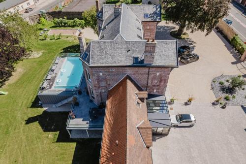 an overhead view of a house with a swimming pool at Aura Castle in Picquigny