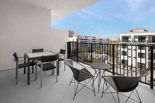 a balcony with a table and chairs on a building at Courtyard by Marriott Clearwater Beach in Clearwater Beach
