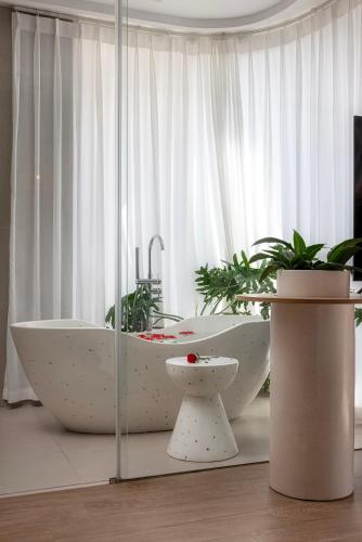 a bathroom with a white bath tub and a toilet at Tropical Paradise Sapa Hotel & Tour in Sa Pa