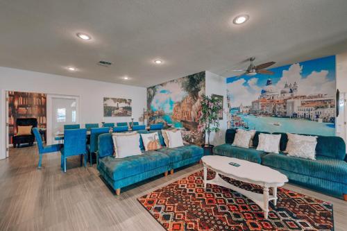 a living room with blue couches and a table at Villa Del Sol in Henderson