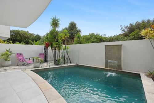 a swimming pool in the middle of a backyard at Ramada By Wyndham Marcoola Beach in Marcoola
