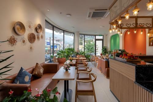 a restaurant with a row of tables and chairs at Tropical Paradise Sapa Hotel & Tour in Sa Pa