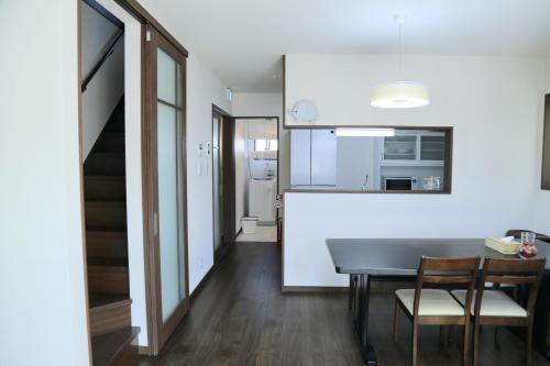 a kitchen and dining room with a table and chairs at 雅舍12 Osaka house new open一軒家貸切 in Osaka