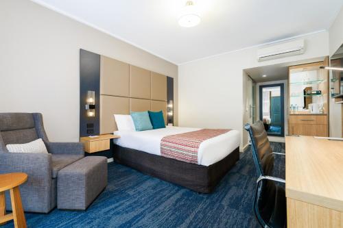 a hotel room with a bed and a couch at Quality Hotel Parklake Shepparton in Shepparton