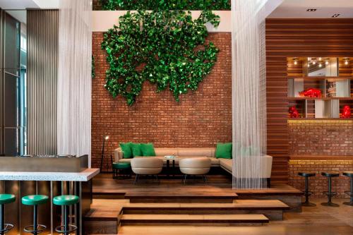 a restaurant with a couch and chairs against a brick wall at W Taipei in Taipei