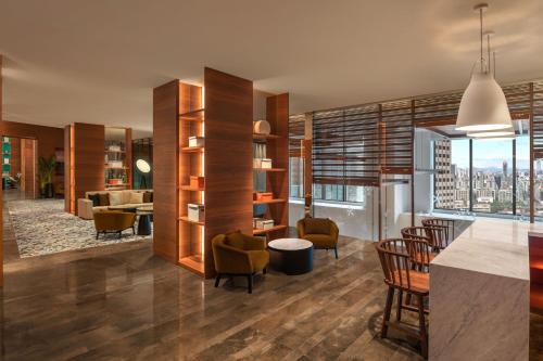 a living room with a view of the city at W Taipei in Taipei