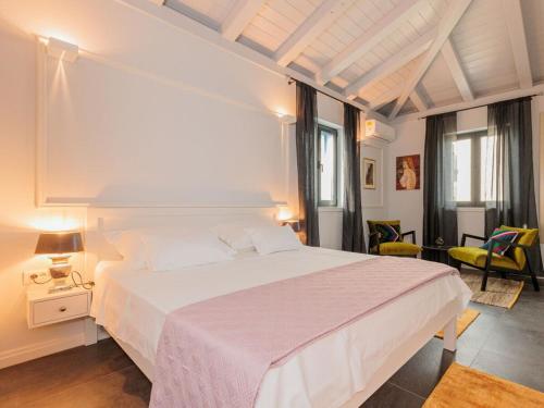 a bedroom with a large white bed in a room at Seafront Villa Adriatica with pool in Dobropoljana