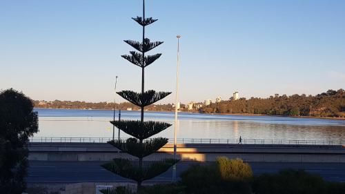 a statue in front of a body of water at Moon River, South Perth in Perth