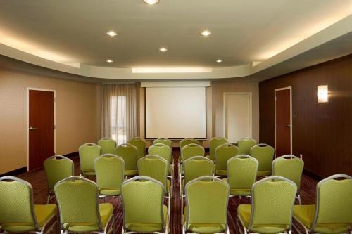 a room with rows of chairs and a screen at Courtyard by Marriott Jackson in Jackson