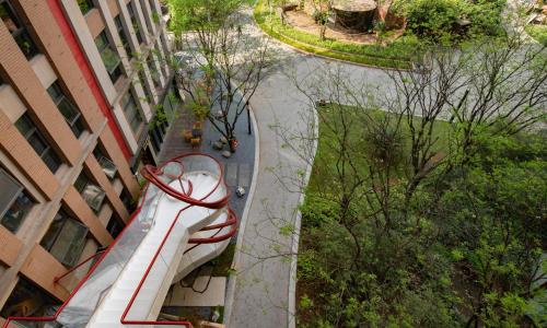 a roller coaster in a park next to a building at 重庆文里苗品茶艺术酒店Chongqing Jiangbei Airport Creative Park Store in Renhe