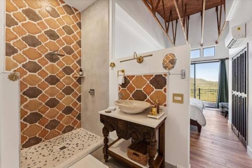 a bathroom with a stone wall with a sink in it at Ranch in Elgin