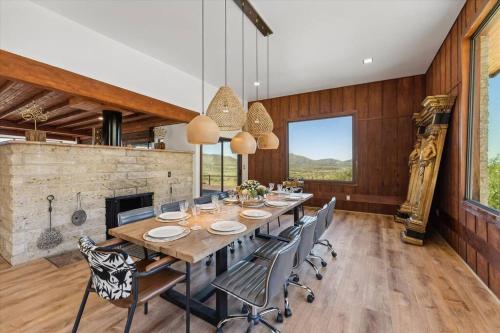 a dining room with a table and chairs and a fireplace at Ranch in Elgin