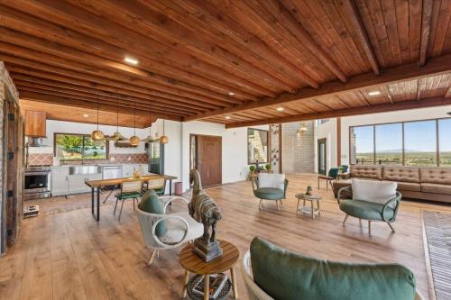 a living room with wooden ceilings and a table and chairs at Ranch in Elgin