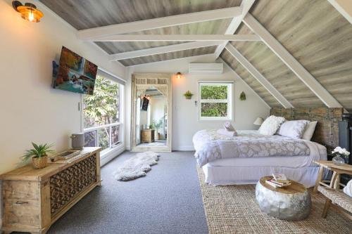 a bedroom with a large bed and a large window at Serenity 222 The Estate in Jervis Bay in St Georges Basin