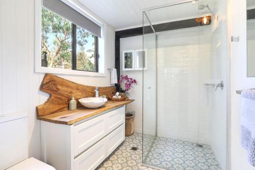 a bathroom with a sink and a shower at Serenity 222 The Estate in Jervis Bay in St Georges Basin