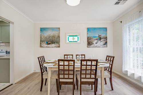 a dining room with a table and chairs at Jetty Road Retreat - Brighton - C21 SouthCoast Holidays in Brighton