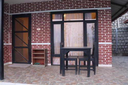 a black chair sitting in front of a brick building at Srijana Farm in Pālpā