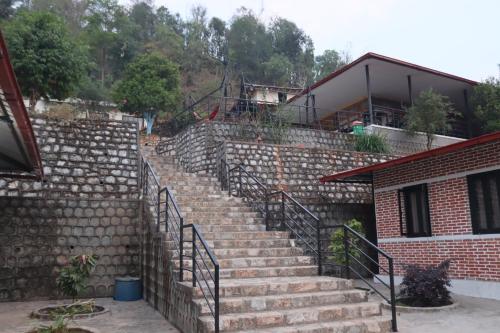 a set of stone stairs in front of a building at Srijana Farm in Pālpā