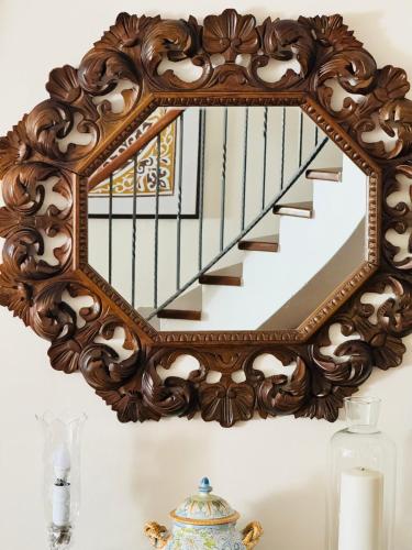 a mirror hanging on a wall next to a staircase at Gio Country House in Nicosia