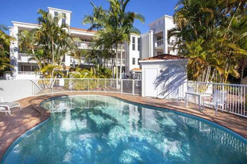 a large swimming pool in front of a building at Burleigh Heads Koala Park Pool & Parking in Gold Coast