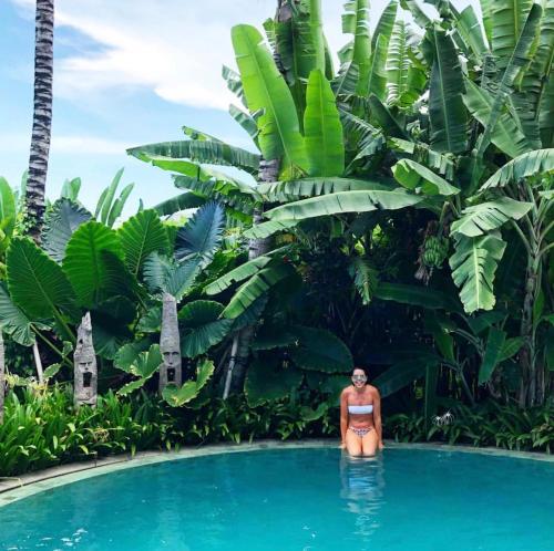 a woman in a bikini standing in a swimming pool at TheSoulHouseBali in Canggu