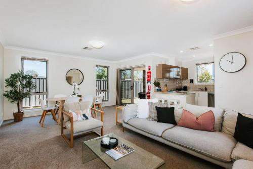 a living room with a couch and a table at Riverlea at The Willows - A Family Country Getaway in Mudgee