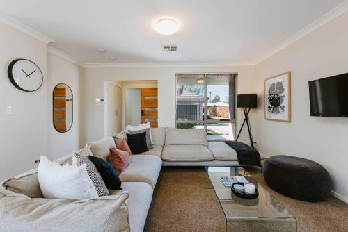 a living room with a couch and a tv at Riverlea at The Willows - A Family Country Getaway in Mudgee