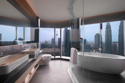 a bathroom with two sinks and a bath tub at Atelier KLCC in Kuala Lumpur