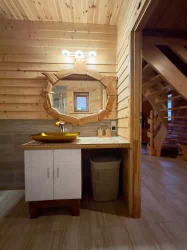 a bathroom with a sink and a mirror at Domki w górach '' Zielone Wzgórza '' okolice Karpacza in Karpacz