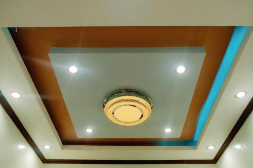 a coffered ceiling with a light in a room at Rb's Three Storey House in Zamboanga