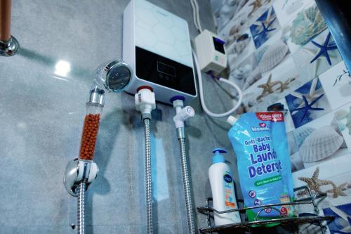 a bathroom counter with toothbrushes and toothpaste and a sink at Rb's Three Storey House in Zamboanga