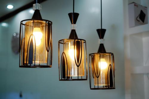 a group of five glass lights hanging from a ceiling at Rb's Three Storey House in Zamboanga