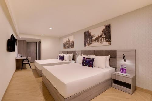 Cama o camas de una habitación en Keys Lite by Lemon Tree Hotels, Vadodara